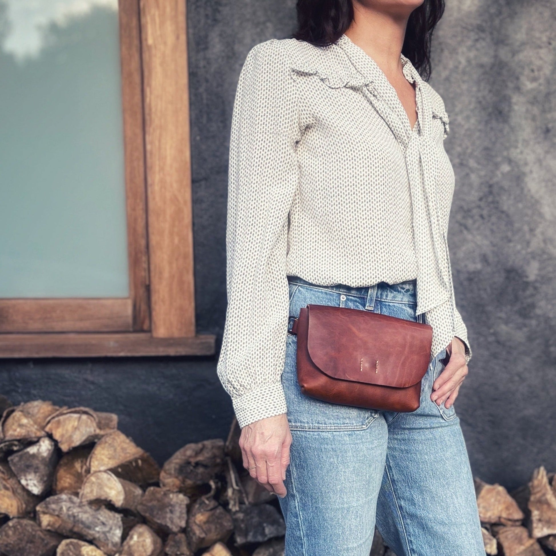 Model wears the Mackenzie hip bag, cognac tan colour way