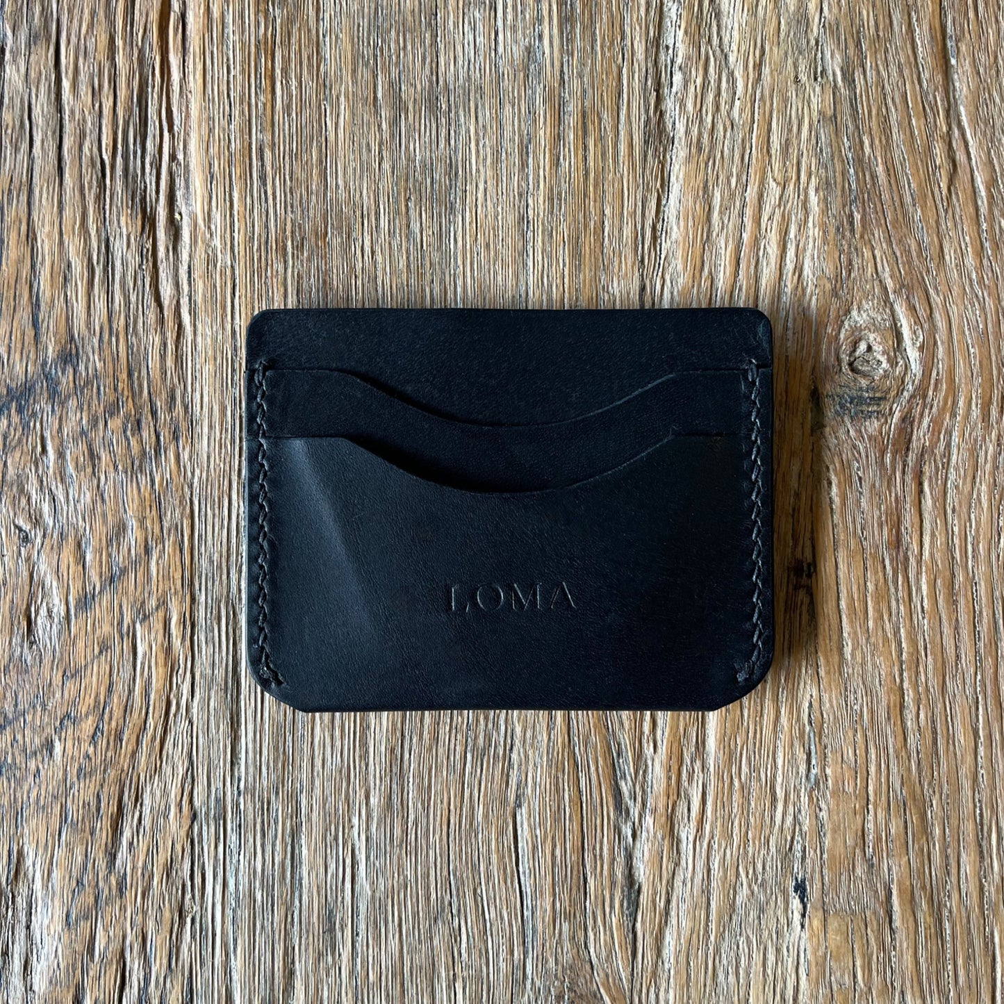 A five slot Italian leather card holder in black back view