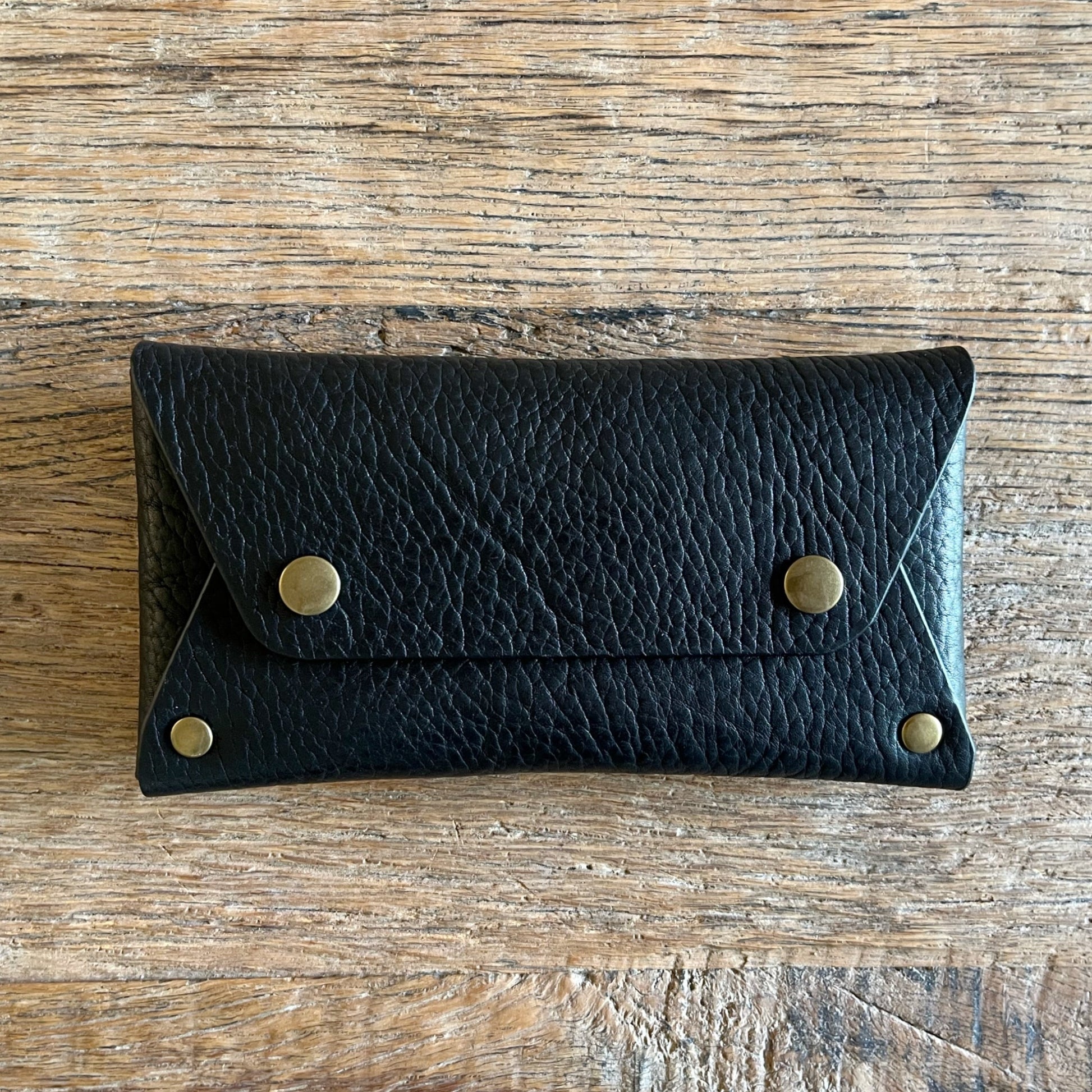 Stevie black wallet with brass snap closure front view