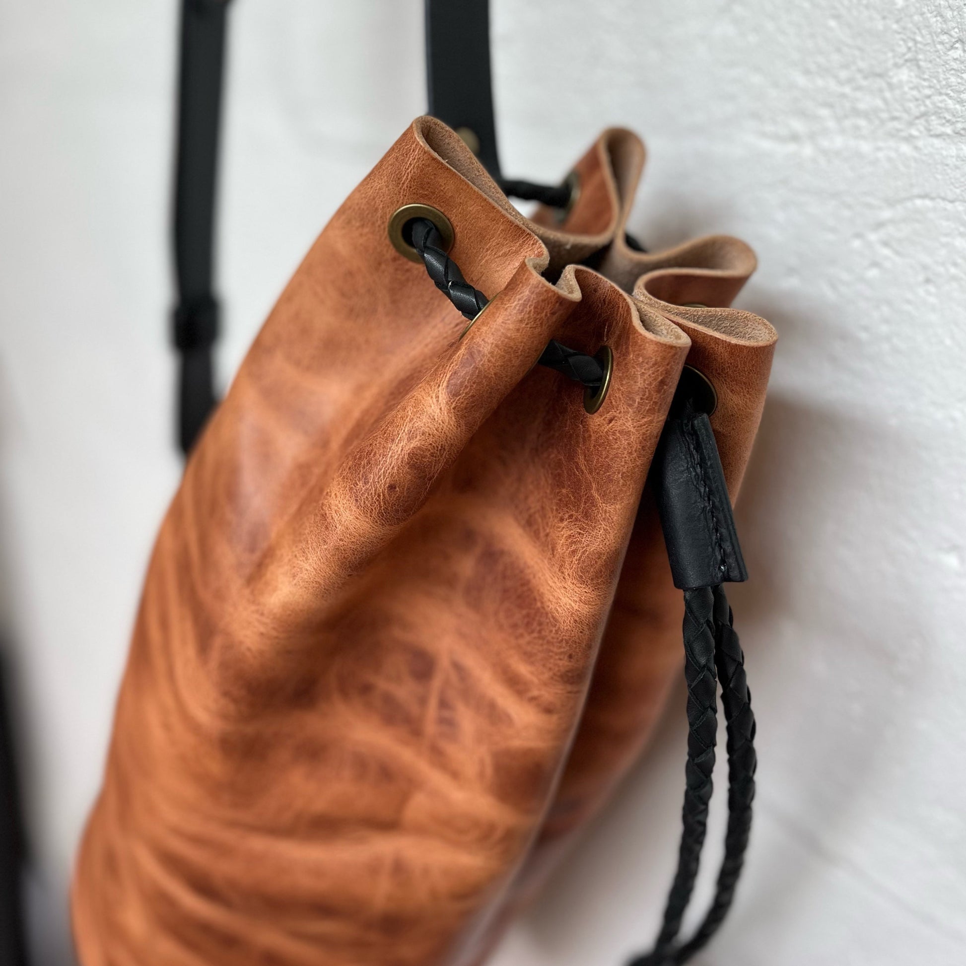 Brown leather drawstring bag on a white background