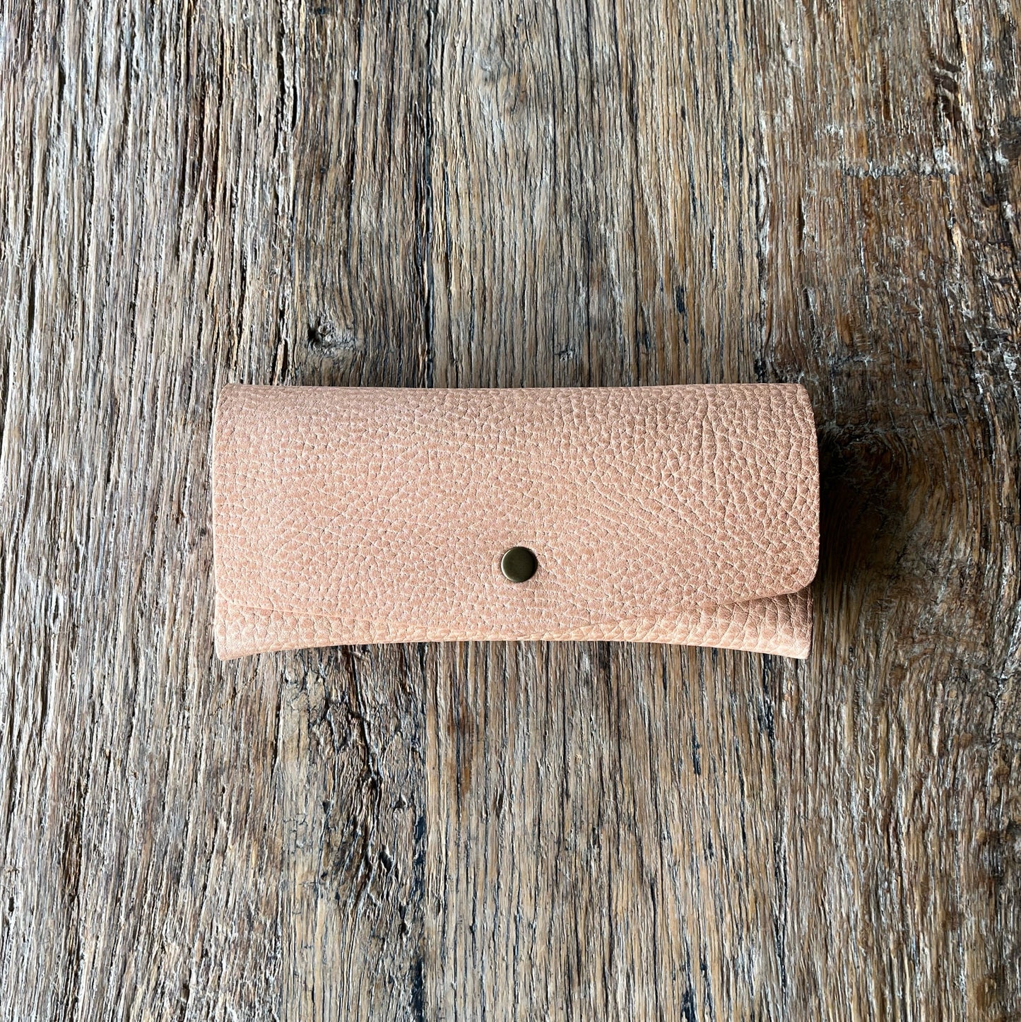 natural leather glasses case on a wooden surface