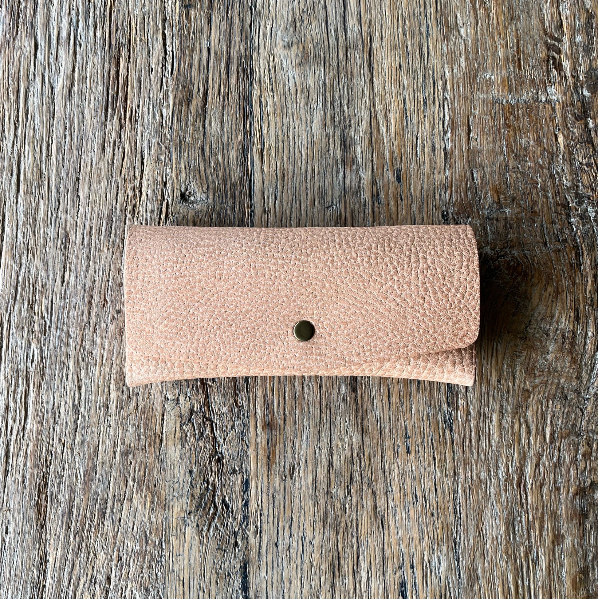 natural leather glasses case on a wooden surface